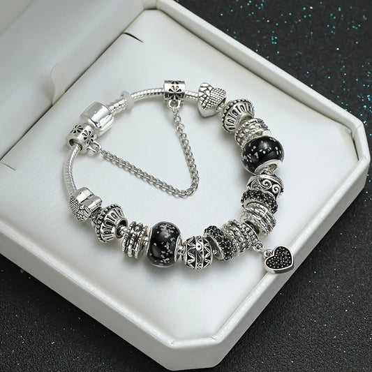 Vintage silver and black bead charm bracelet featuring heart-shaped charms - the perfect hand jewelry gift for women.