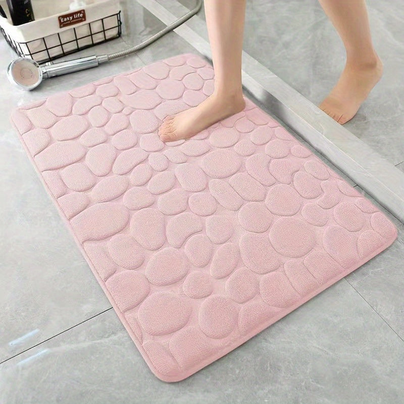 Soft and comfortable memory foam bath rug featuring cobblestone embossment. Rapid water absorbency and washable. Non-slip bathroom accessory.