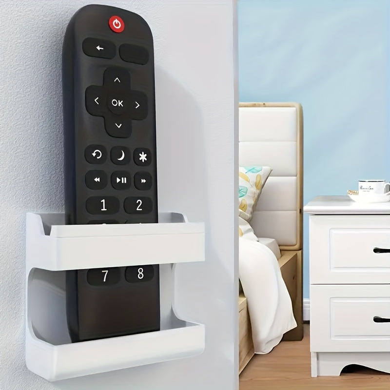 Wall-mounted storage bracket for phones and remotes, no drilling required.