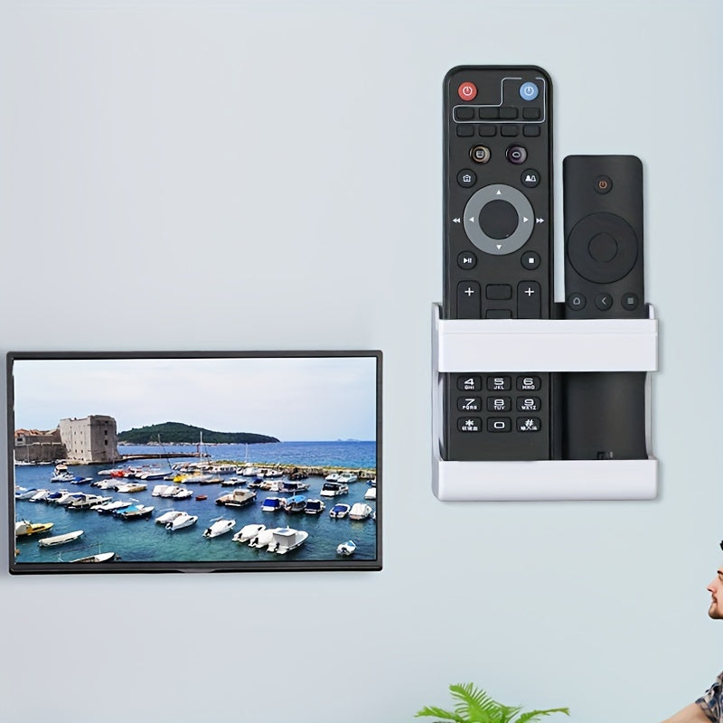 Wall-mounted storage bracket for phones and remotes, no drilling required.