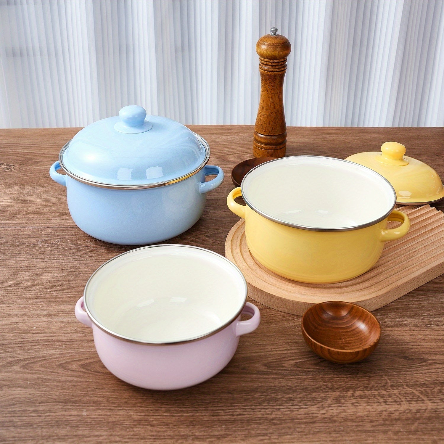 Enamel pot set including a soup pot, stew pot, and boiling pot for use in restaurants or home kitchens. Suitable for gas, electric stoves, and open fire cooking, but not safe for use in microwave ovens. Ideal kitchenware supplies.