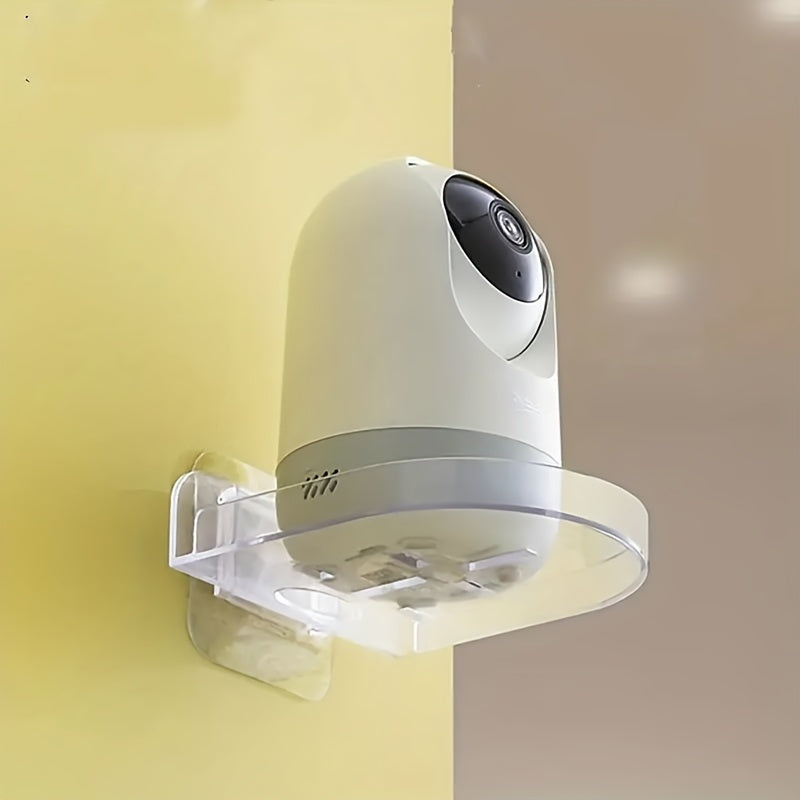 Wall-mounted camera bracket with adhesive, no drilling required, for storing monitoring equipment.