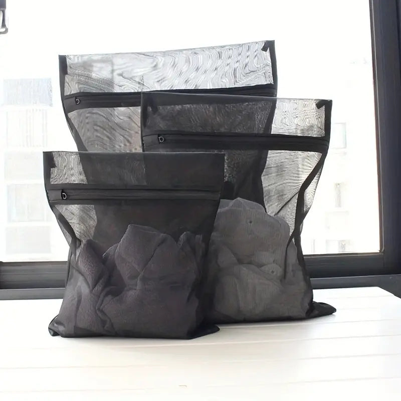 Set of three durable mesh laundry bags designed for delicate items - prevents clothes from getting wrinkled or stained, great for larger pieces, perfect for use at home or in dorms. Ideal for laundry care.