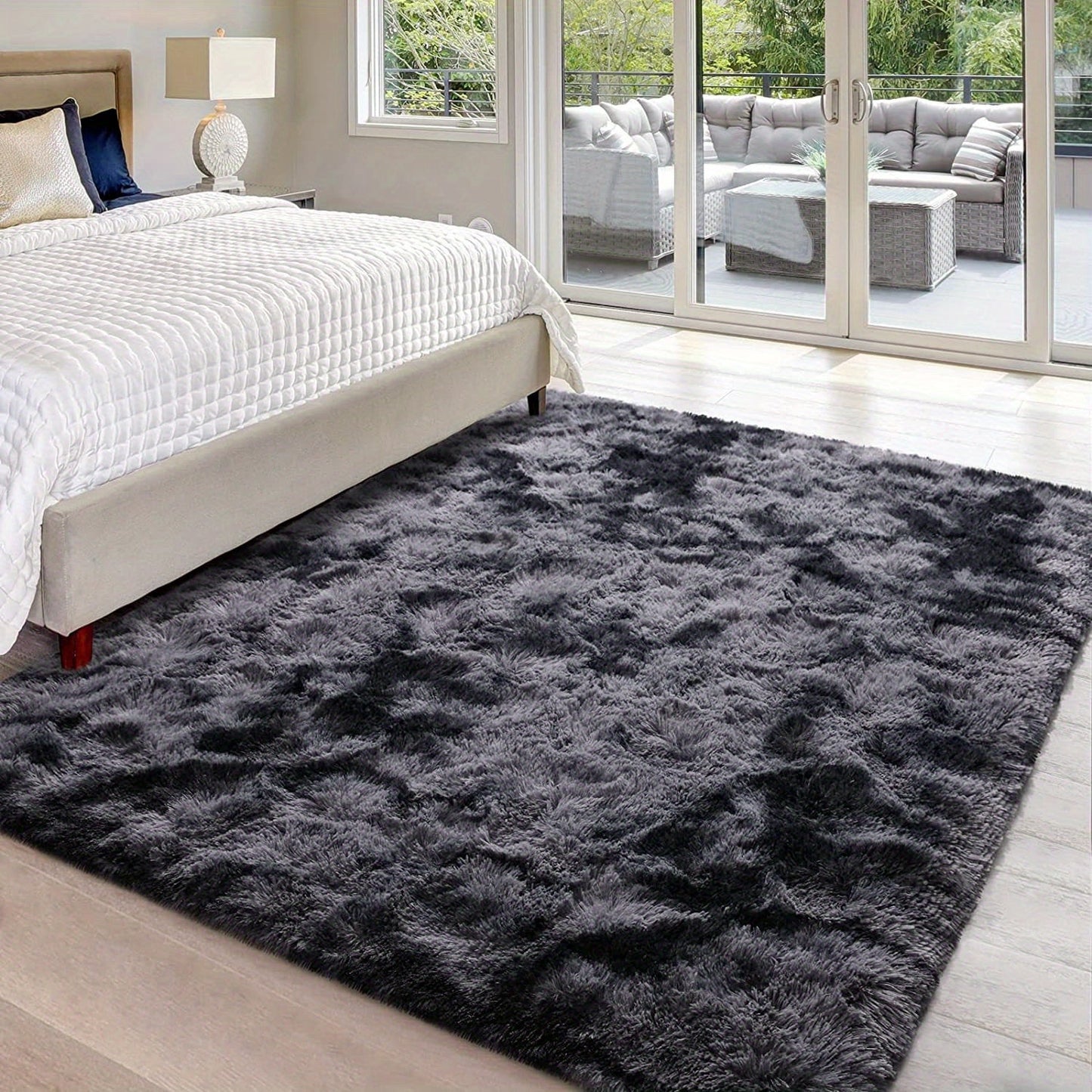 Luxurious non-slip dark gray carpet with a cute and soft fluffy shag design, perfect for living rooms and bedrooms. Machine washable and ideal for adding a touch of luxury to home decor.