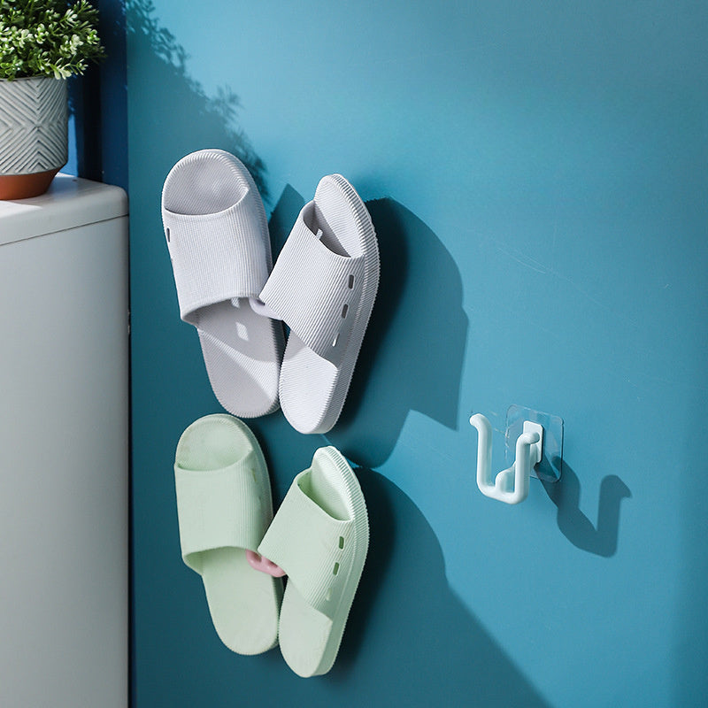 Space-saving shoe rack that can be mounted on walls, made of durable plastic with a drain design. This slipper holder does not require drilling and is suitable for bathroom or wardrobe storage. Easy to install and does not need electricity to dry shoes.