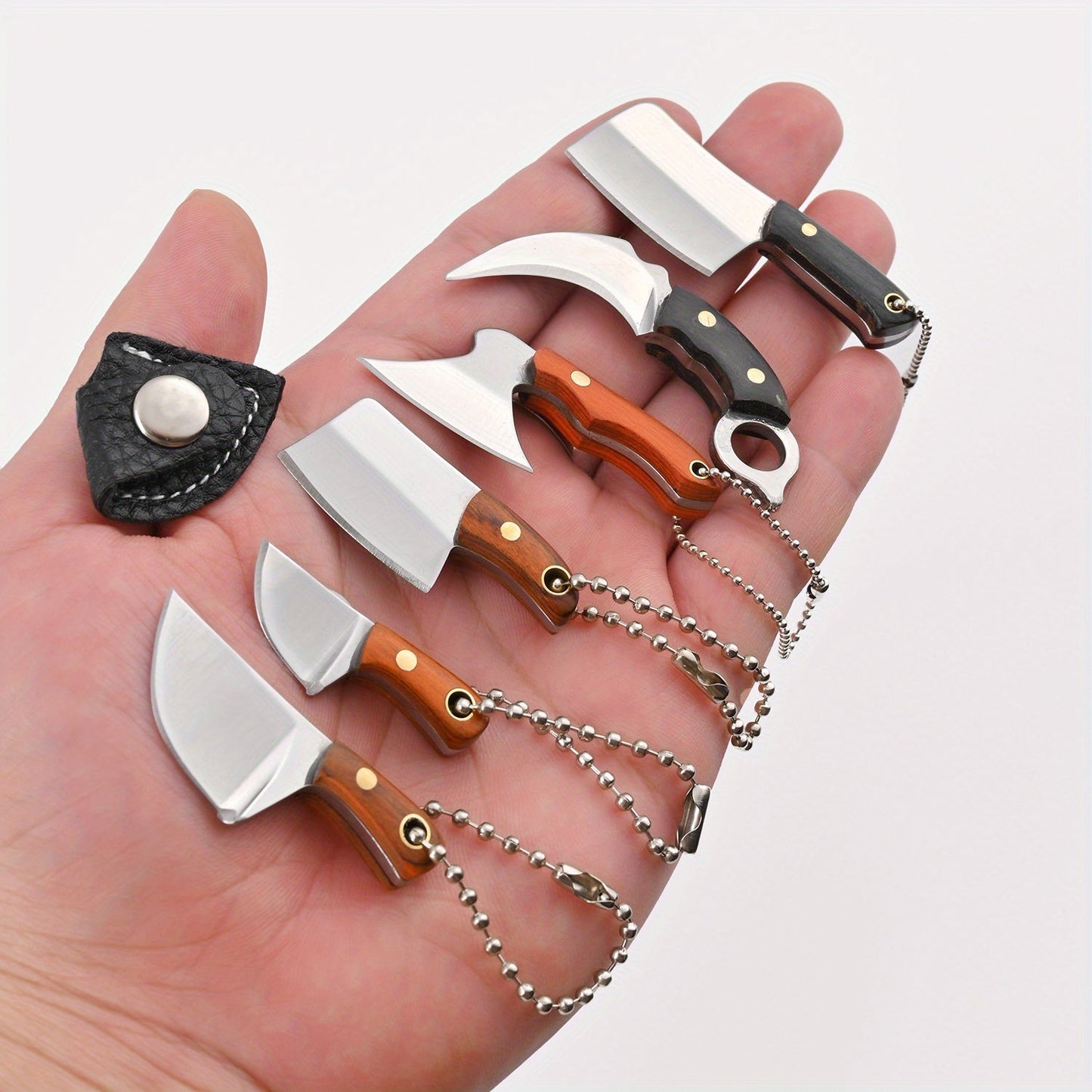 Set of 6 mini knives with sheaths, including a chef knife, EDC bottle opener, and keychains. Also includes a small cleaver and pocket knife.