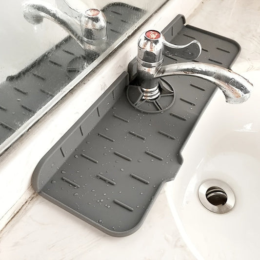 Waterproof and easy-to-clean silicone mat designed to catch faucet water, with drainage system and non-electric absorbent properties. Ideal as a sink splash guard and kitchen counter protector pad.