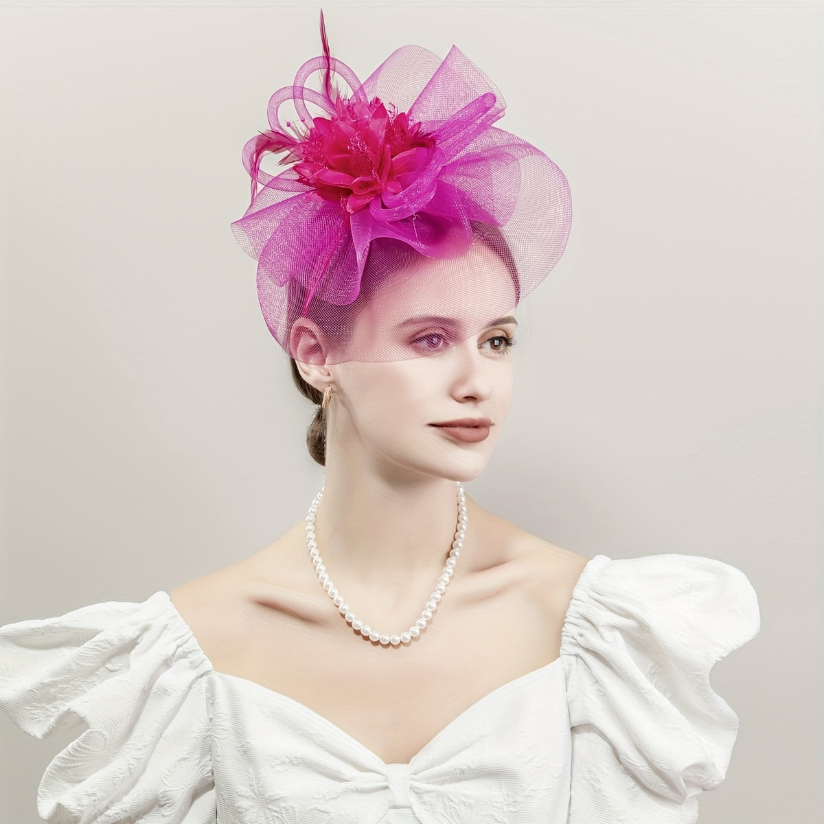 One piece of women's hair accessory featuring a mesh flower, faux feather detailing, and veil perfect for birthday parties, the Jockey Club, weddings, derby hats, and church events.