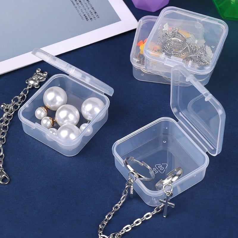 6 Mini clear plastic storage boxes with snap lids, ideal for organizing jewelry, earrings, and small items. Perfect for modern home decor and secure storage.