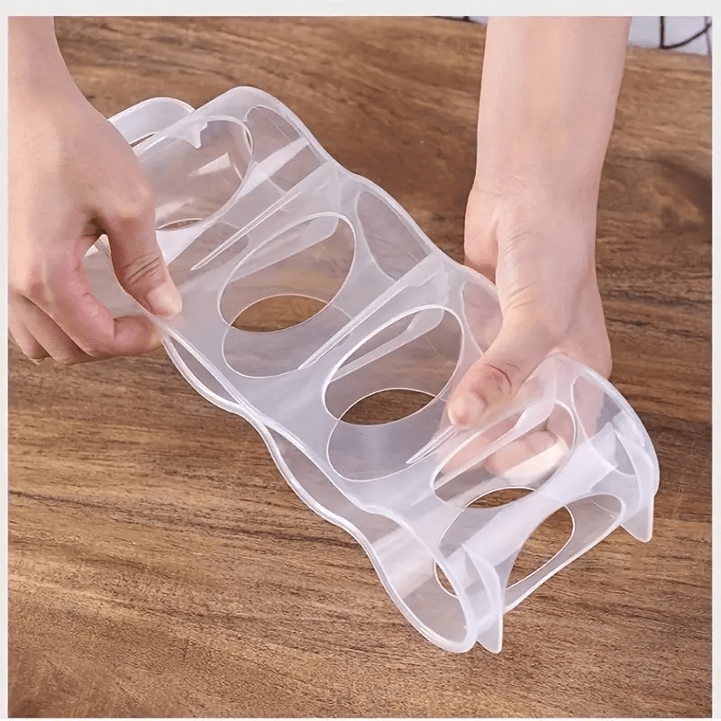 Clear plastic storage box with 4 compartments for soda cans, ideal for organizing your kitchen countertops, cabinets, and refrigerator. A convenient and portable solution for keeping your kitchen organized.