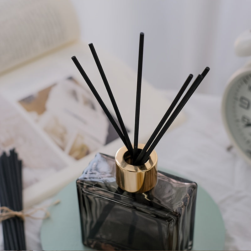 25 elegant fireless rattan reed diffuser sticks with black labels and golden cap for home decor and relaxation.