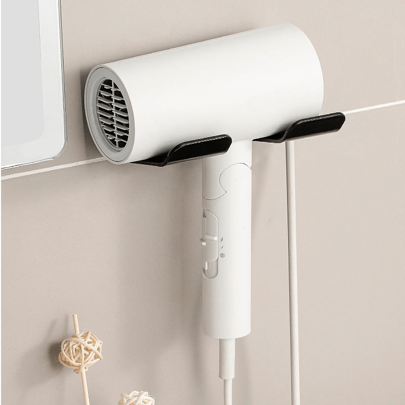 Wall-mounted storage rack keeps hair dryer and accessories neat without drilling.