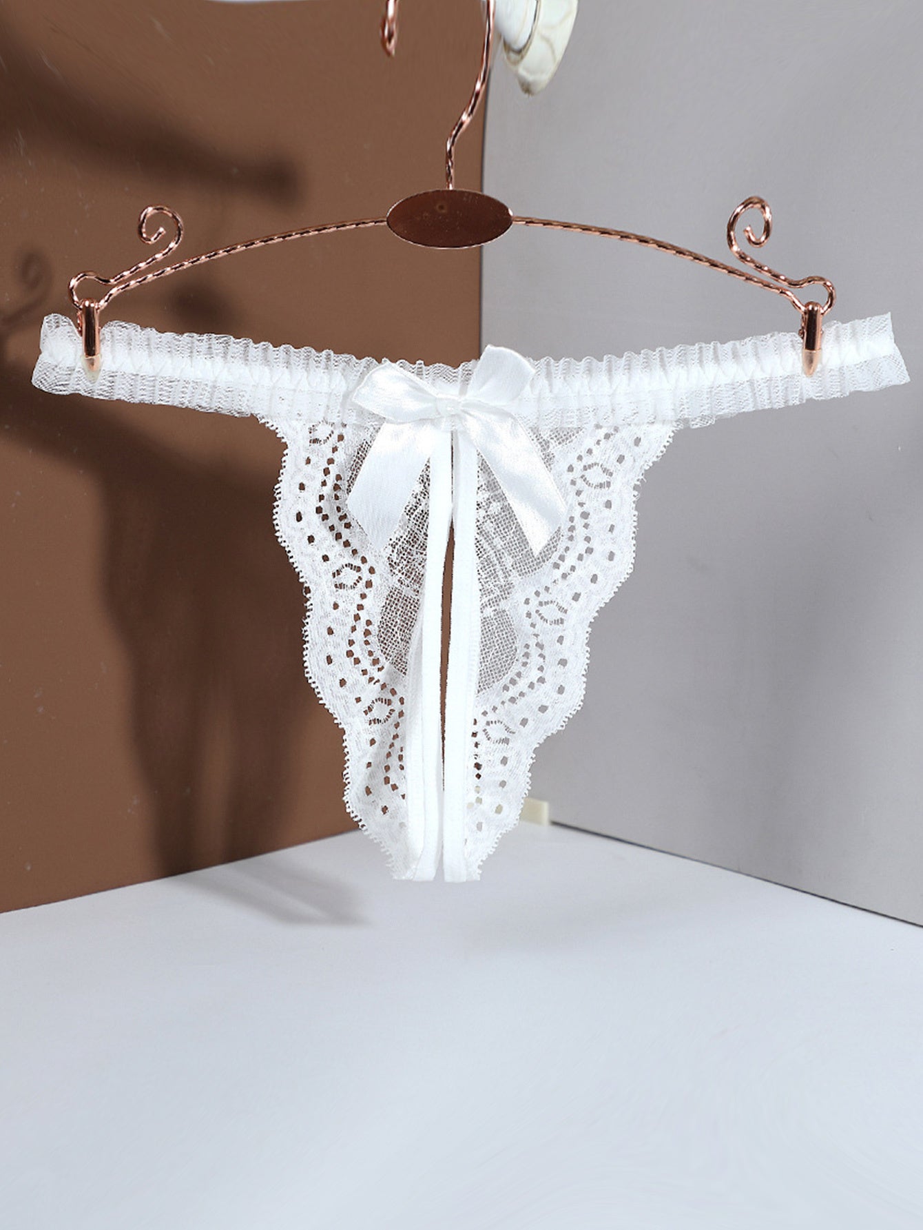 Stylish crotchless thongs featuring a solid bow decor and jacquard lace for a sexy and comfortable option in women's lingerie.