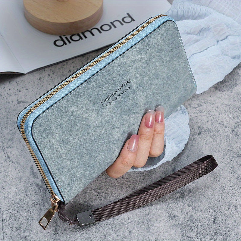 Women's long wallet with multi-function card holder, phone pocket, wrist strap, and made of PU leather.