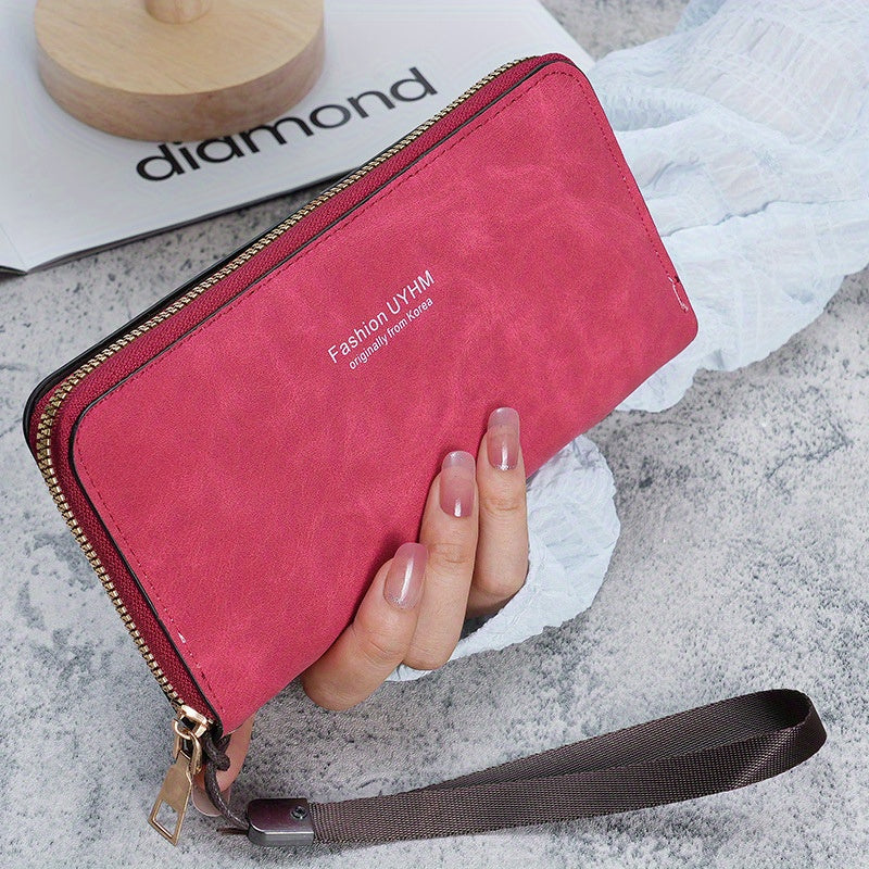 Women's long wallet with multi-function card holder, phone pocket, wrist strap, and made of PU leather.