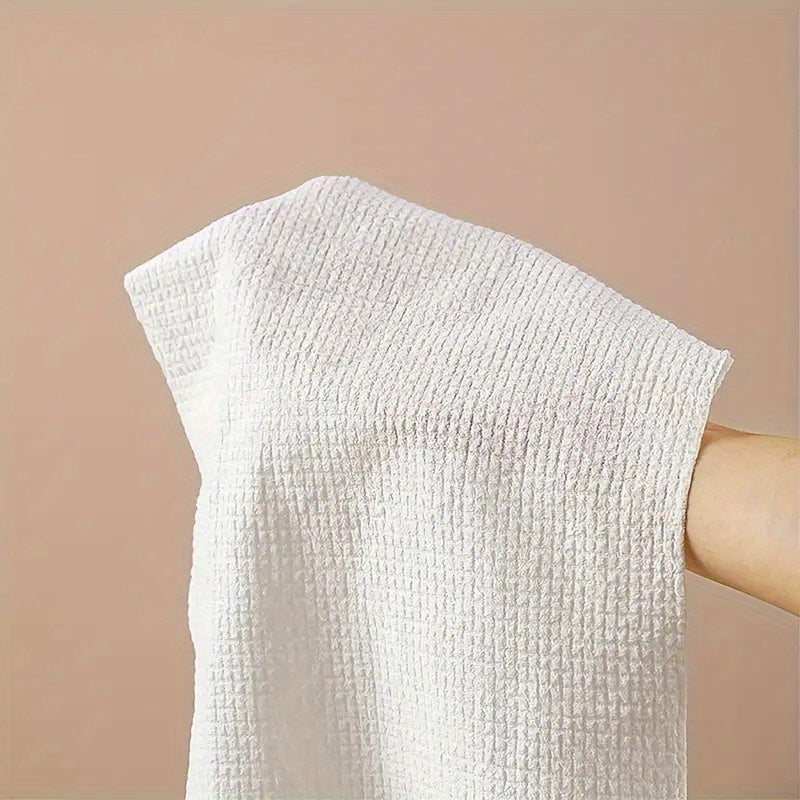 Pack of 25 disposable bath towels made from wood pulp fiber, non-woven fabric, and quick-dry technology. These extra-large towels are perfect for bathroom cleaning, travel, and are individually wrapped for convenience. Highly absorbent and essential for