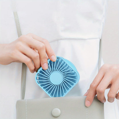 Mini Foldable Desktop Block with Mirror, Multi-functional Handheld Portable Pocket Fan with USB Charging. Can be used as a Hanging Neck Fan or placed on a Desktop. Features Mute Operation and Large Wind Output. Ideal for Creative Desktop Use in the