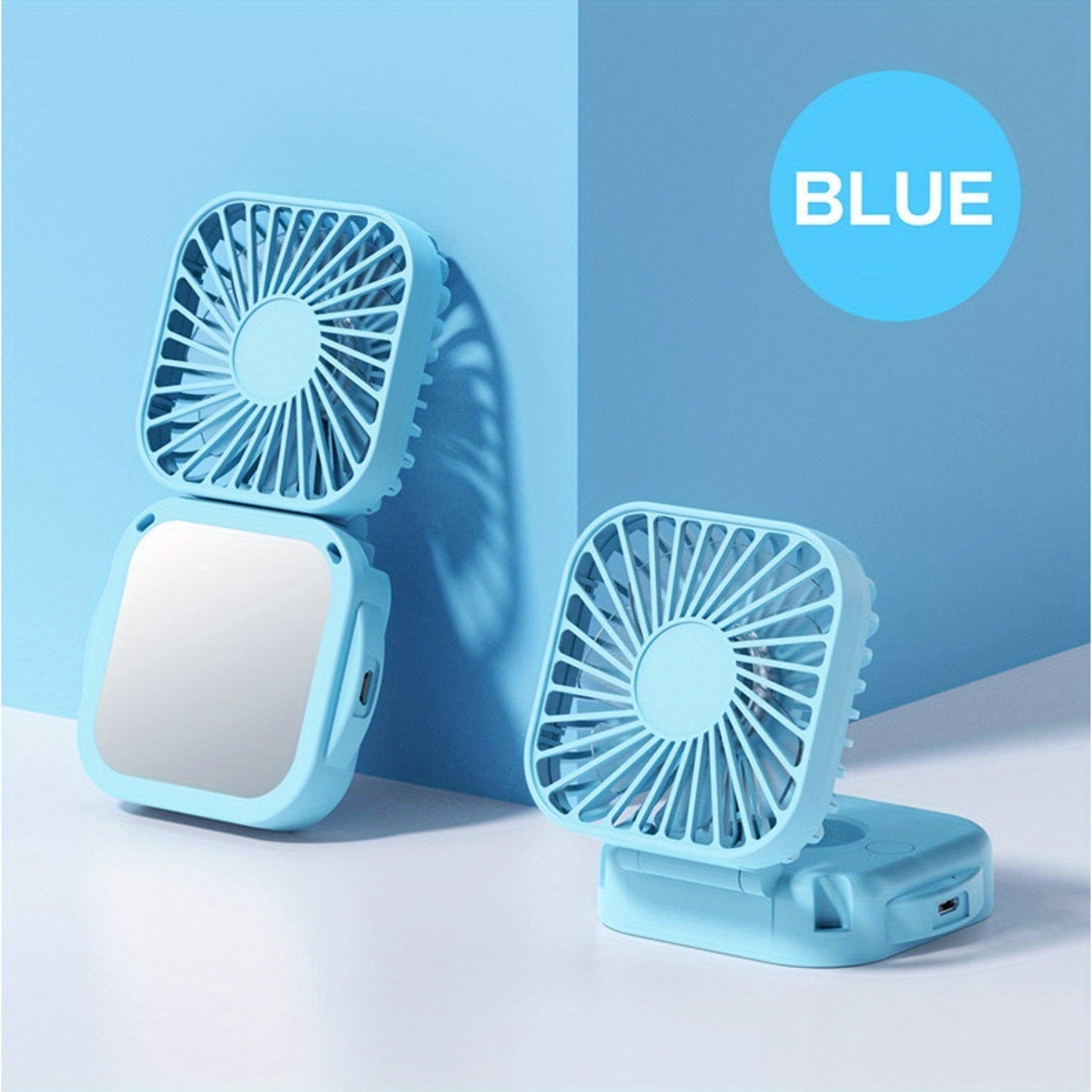 Mini Foldable Desktop Block with Mirror, Multi-functional Handheld Portable Pocket Fan with USB Charging. Can be used as a Hanging Neck Fan or placed on a Desktop. Features Mute Operation and Large Wind Output. Ideal for Creative Desktop Use in the