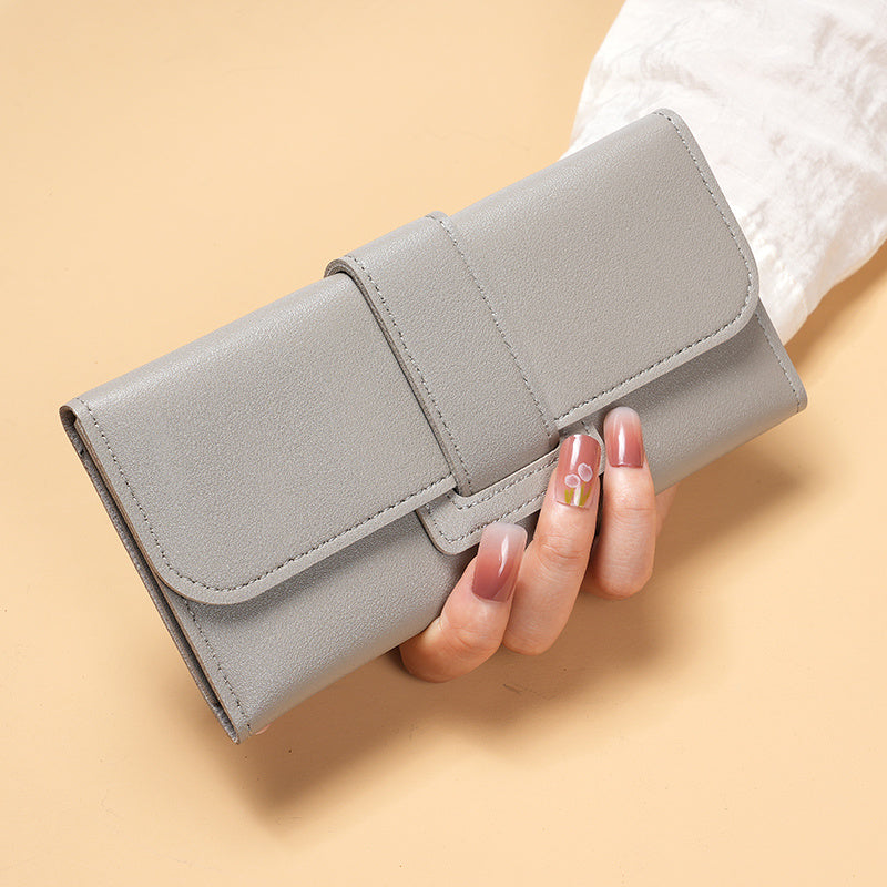 Stylish women's long wallet with multiple card slots and coin purse, features a chic buckle clutch for mobile phone.