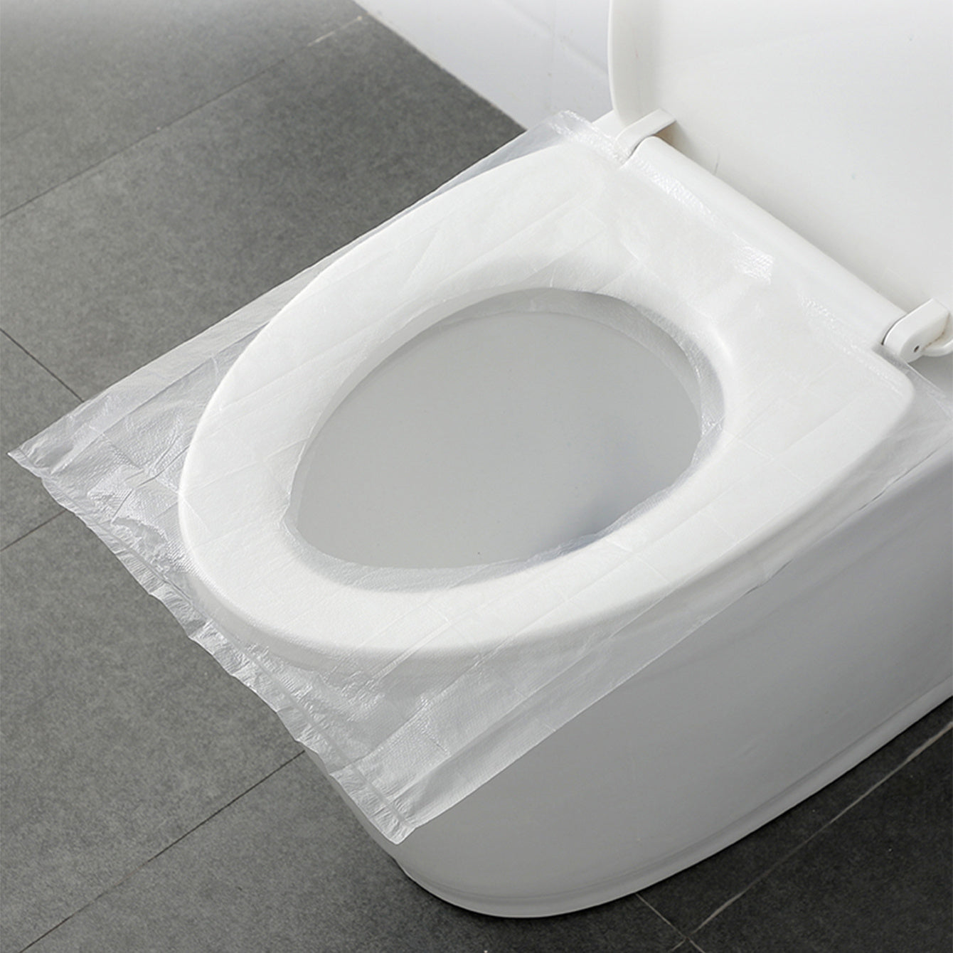 50 portable disposable toilet seat covers, transparent plastic, waterproof and hygienic, cushioned paper alternative for travel.