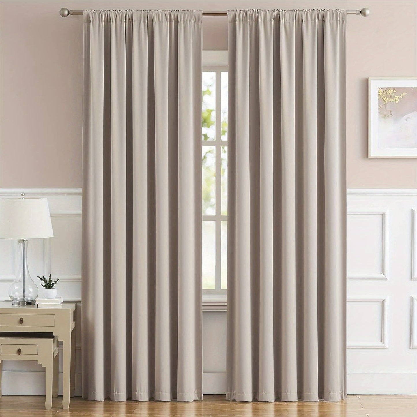 Cream and black thermal insulated blackout curtains with two panels. Perfect for darkening a room and providing insulation. Features back tab and rod pocket design for easy installation in a living room.