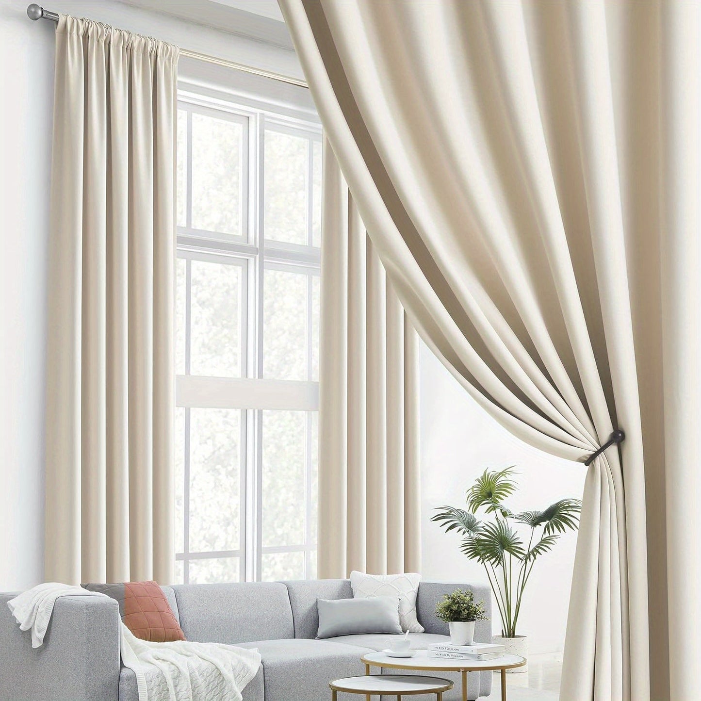 Cream and black thermal insulated blackout curtains with two panels. Perfect for darkening a room and providing insulation. Features back tab and rod pocket design for easy installation in a living room.