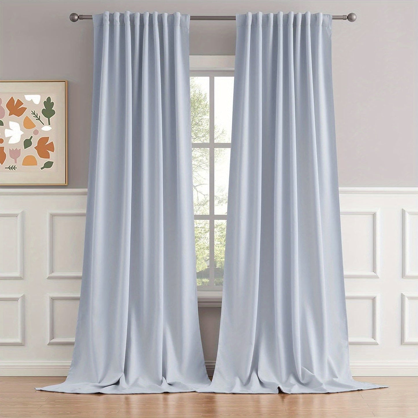 Cream and black thermal insulated blackout curtains with two panels. Perfect for darkening a room and providing insulation. Features back tab and rod pocket design for easy installation in a living room.