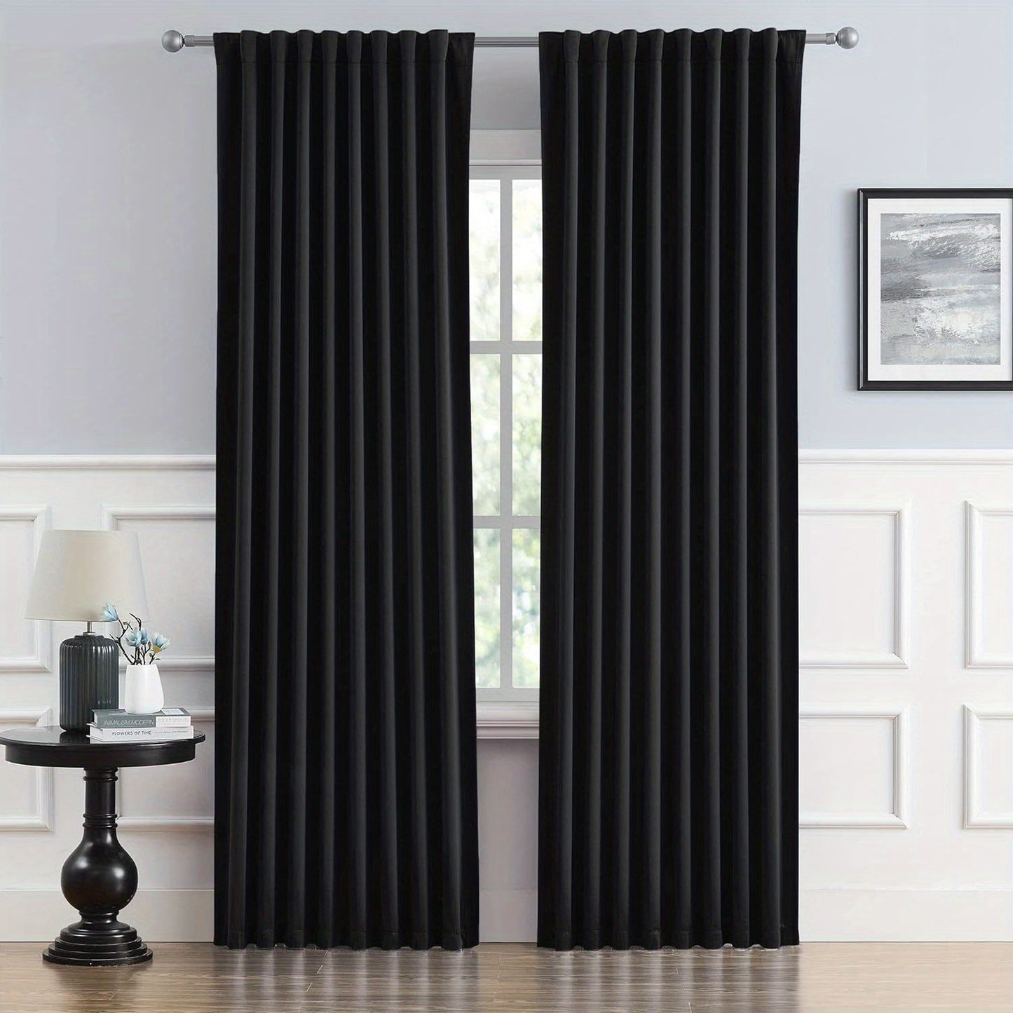 Cream and black thermal insulated blackout curtains with two panels. Perfect for darkening a room and providing insulation. Features back tab and rod pocket design for easy installation in a living room.