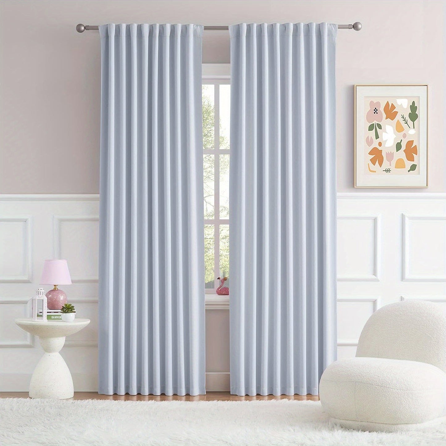 Cream and black thermal insulated blackout curtains with two panels. Perfect for darkening a room and providing insulation. Features back tab and rod pocket design for easy installation in a living room.