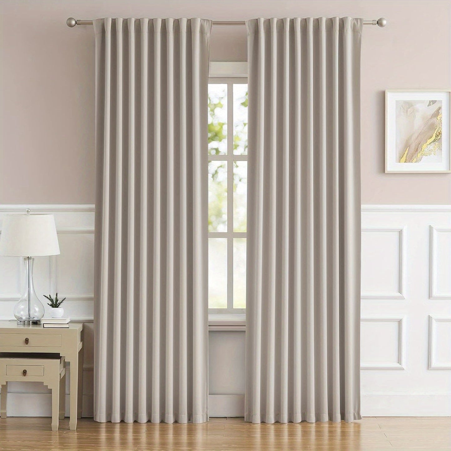 Cream and black thermal insulated blackout curtains with two panels. Perfect for darkening a room and providing insulation. Features back tab and rod pocket design for easy installation in a living room.