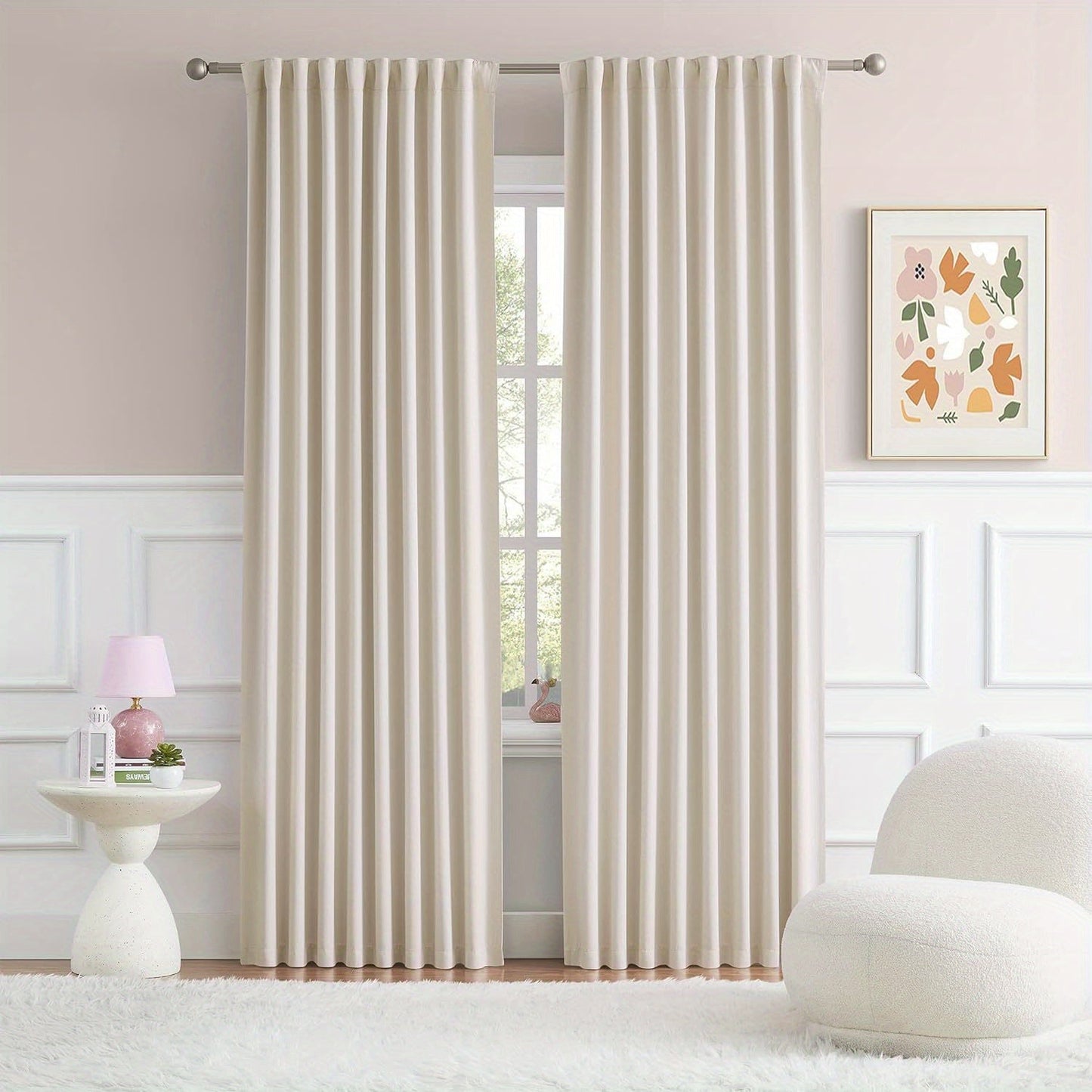 Cream and black thermal insulated blackout curtains with two panels. Perfect for darkening a room and providing insulation. Features back tab and rod pocket design for easy installation in a living room.