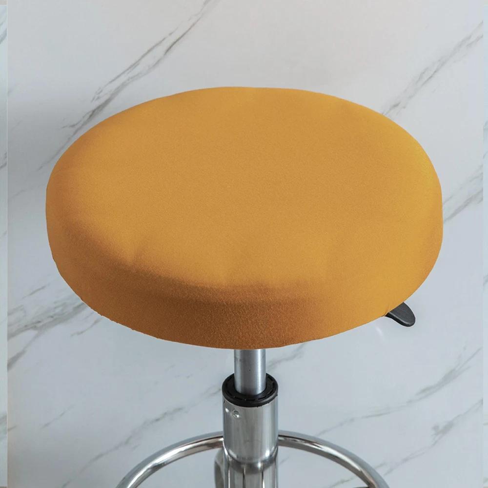 Stretchy round slipcover for bar stool, protecting furniture in dining, living, or office areas.