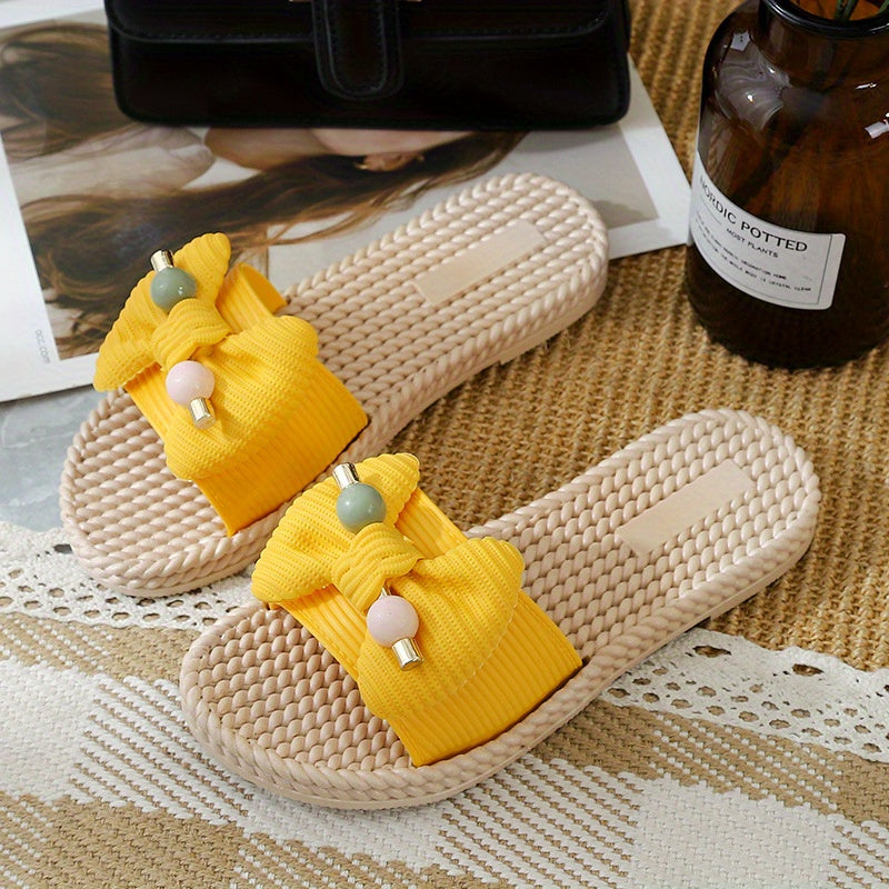 Women's PVC slip-on sandals with bow and bead accents, flat heel, open toe, ideal for beach wear.  Bow embellished, made from synthetic material.