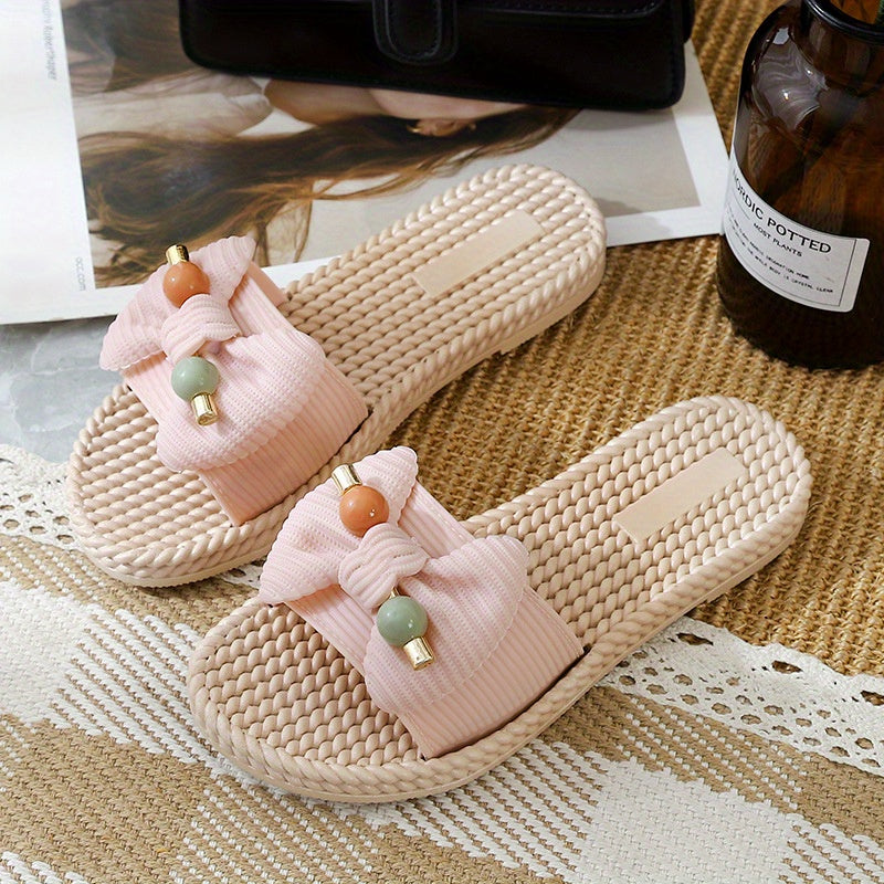 Women's PVC slip-on sandals with bow and bead accents, flat heel, open toe, ideal for beach wear.  Bow embellished, made from synthetic material.