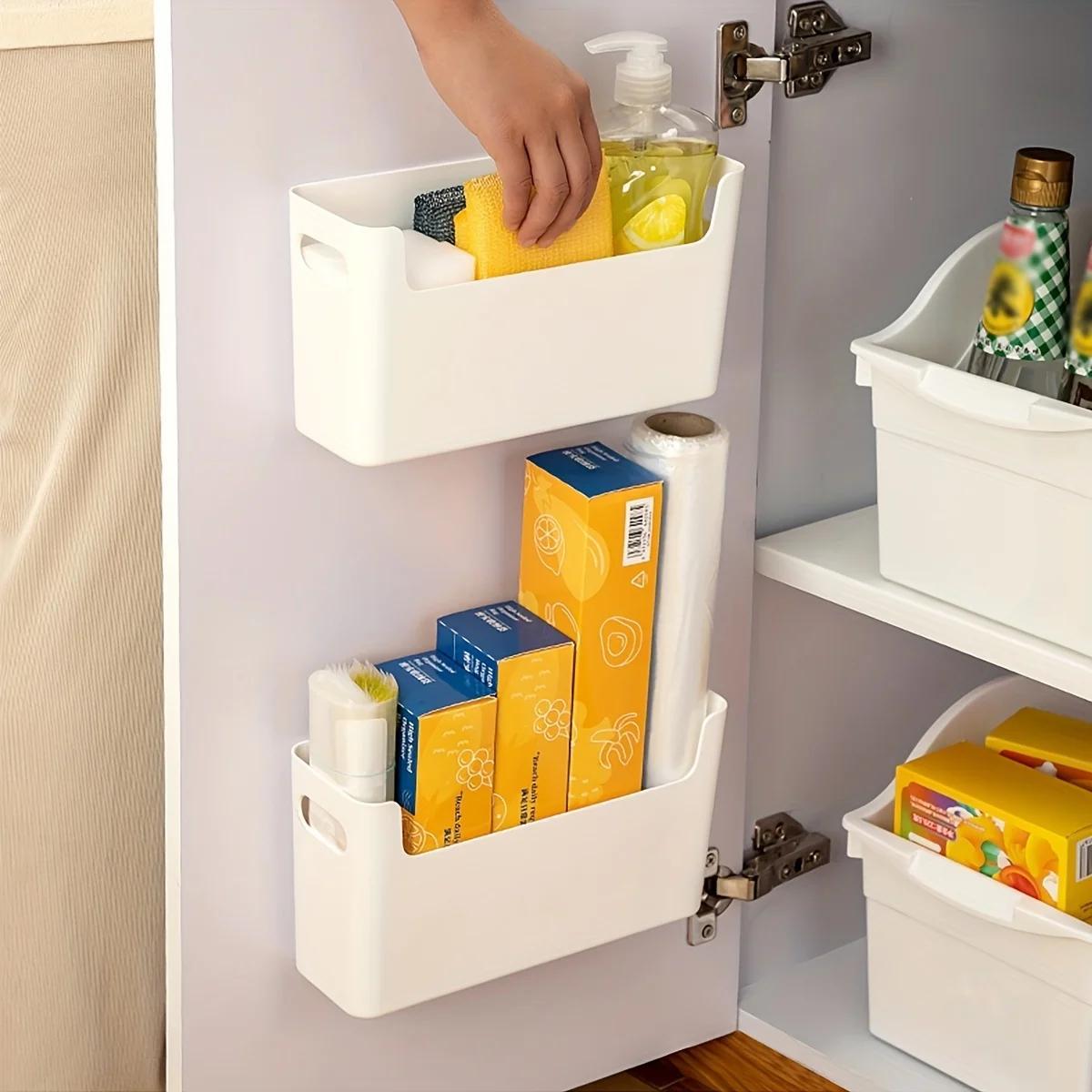 Plastic holder for bags and film with hooks, suitable for home, kitchen, and restaurant. This wall-mounted cabinet door storage organizer is ideal for keeping your kitchen organized.