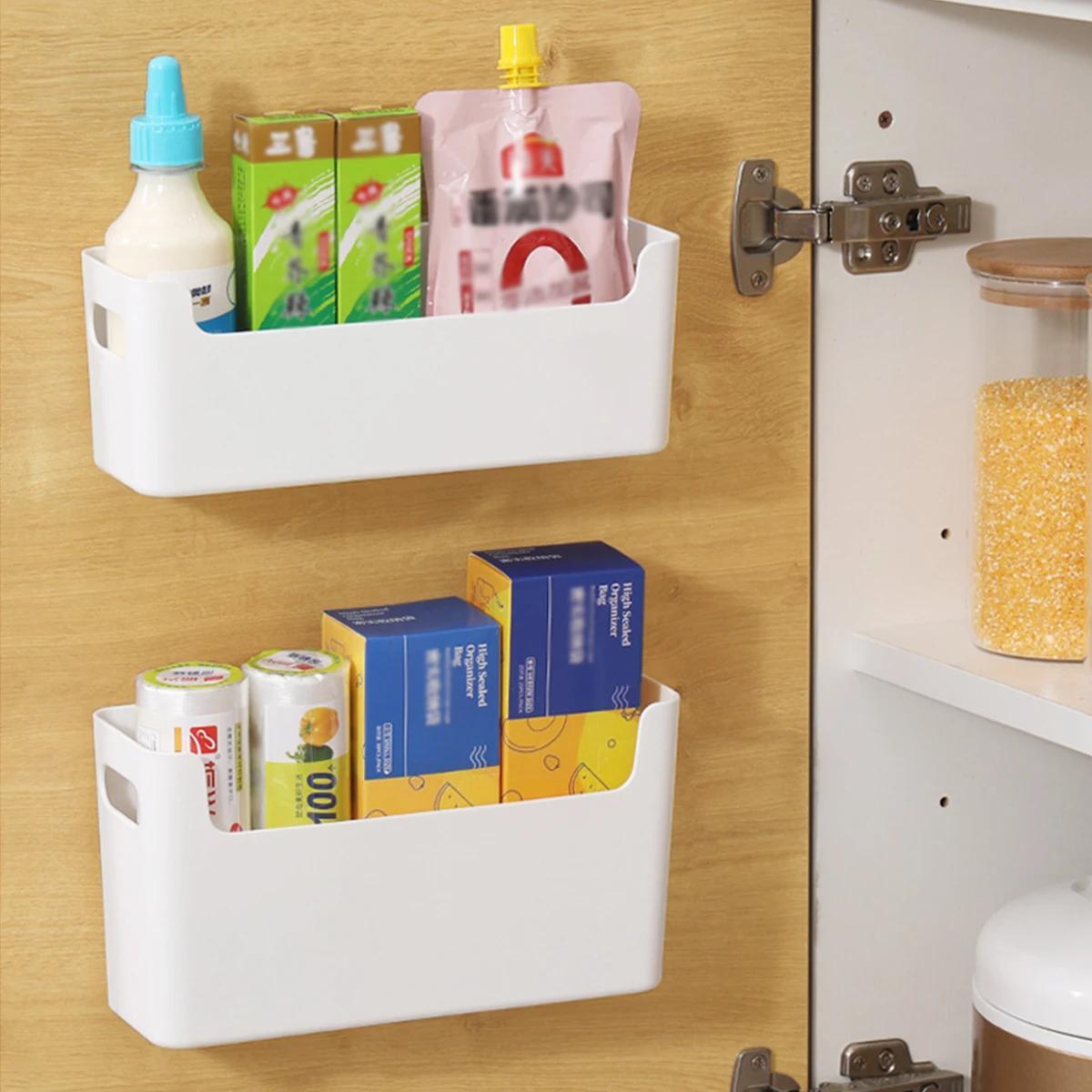 Plastic holder for bags and film with hooks, suitable for home, kitchen, and restaurant. This wall-mounted cabinet door storage organizer is ideal for keeping your kitchen organized.