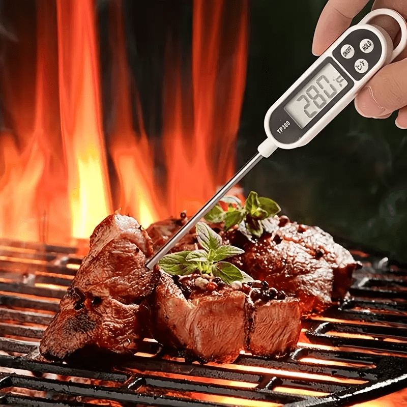 Stainless steel digital food thermometer TP300 with probe, ideal for BBQ, cooking, and baking. Dual display in Celsius & Fahrenheit, battery-operated kitchen tool.