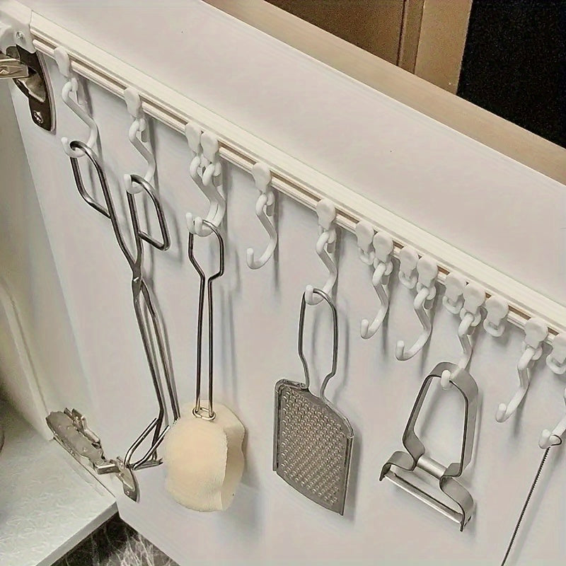 Kitchen storage rack with sliding hooks for easy installation, no drilling necessary; adhesive backing for convenient organization and utility hooks.