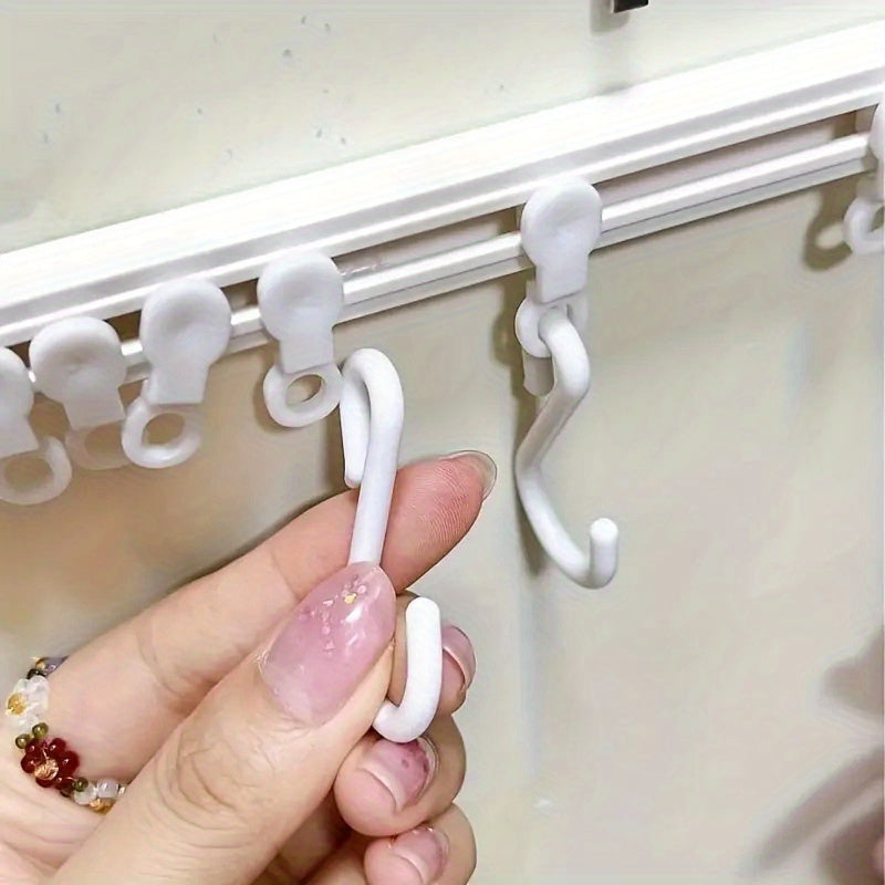 Kitchen storage rack with sliding hooks for easy installation, no drilling necessary; adhesive backing for convenient organization and utility hooks.