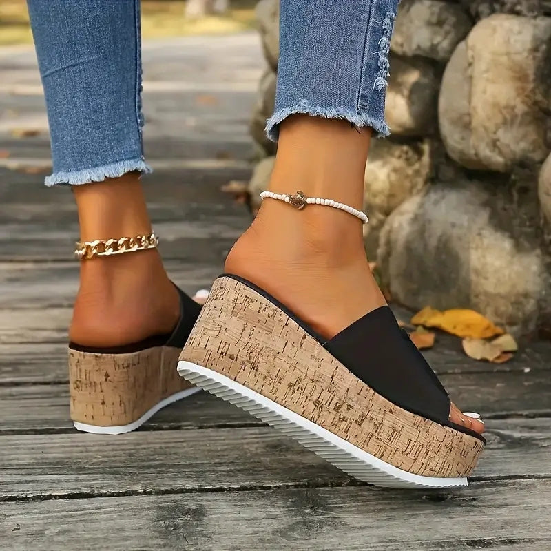 Black slide sandals for women with wood grain sole, open toe, high wedge heel, vegan cover strap, and platform style for summer.