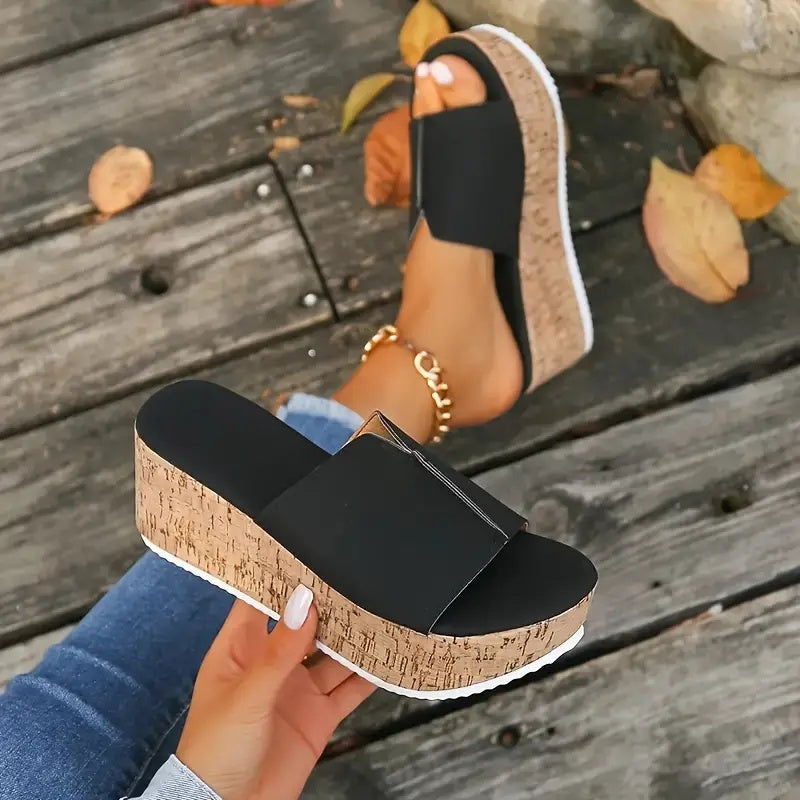 Black slide sandals for women with wood grain sole, open toe, high wedge heel, vegan cover strap, and platform style for summer.