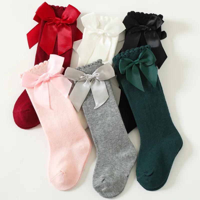 6 pairs of knee-high socks for kids aged 0-5 years in mixed colors, featuring ribbon bows and ruffled princess design.