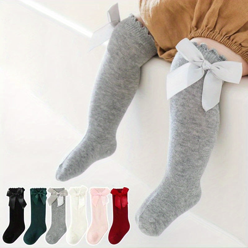 6 pairs of knee-high socks for kids aged 0-5 years in mixed colors, featuring ribbon bows and ruffled princess design.