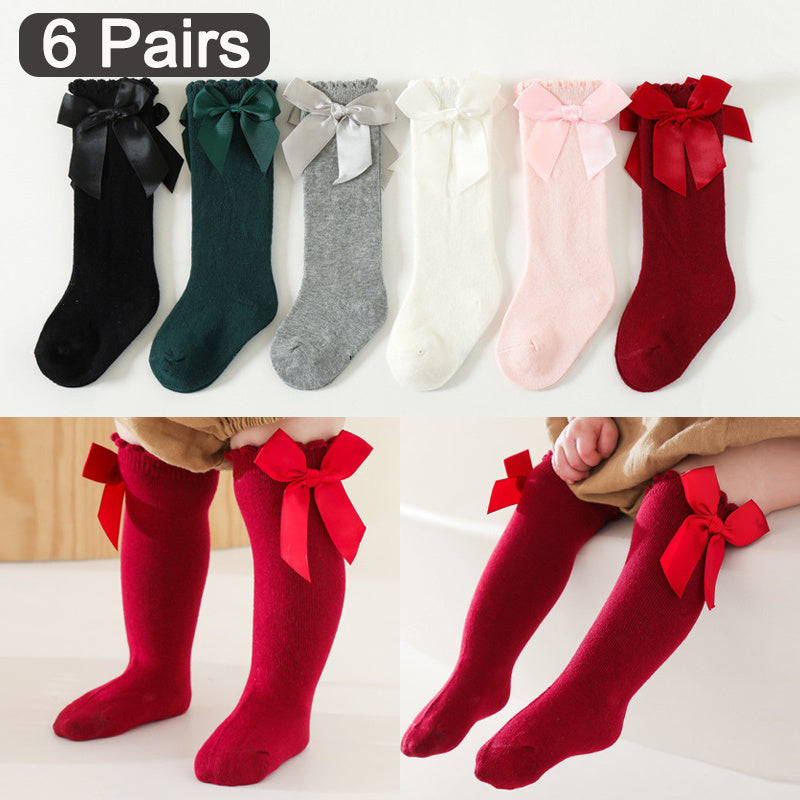 6 pairs of knee-high socks for kids aged 0-5 years in mixed colors, featuring ribbon bows and ruffled princess design.