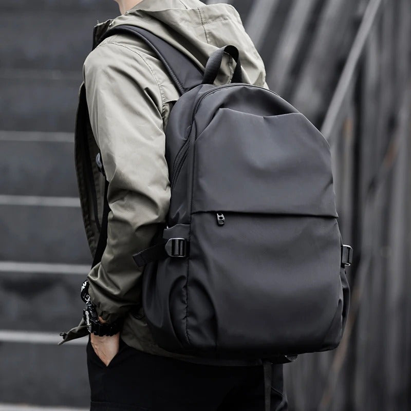 All-in-one men's backpack for travel, business, and daily use - waterproof, spacious, with laptop compartment and USB port.