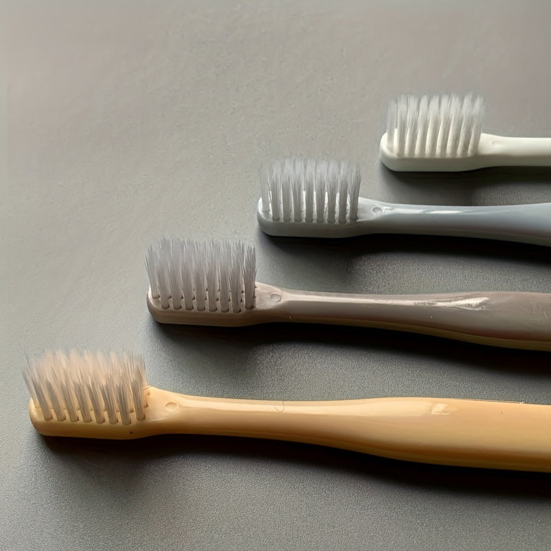 4 Macaron toothbrushes with soft bristles, bamboo charcoal handle, gentle on gums, deep cleaning dental care.