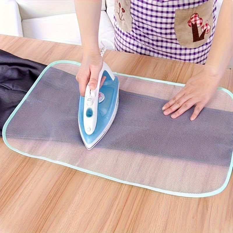 Heat-resistant ironing mat with protective mesh cloth for clothes and ironing board protection. This non-electric steam iron pad is designed to keep your ironing surface safe and damage-free.