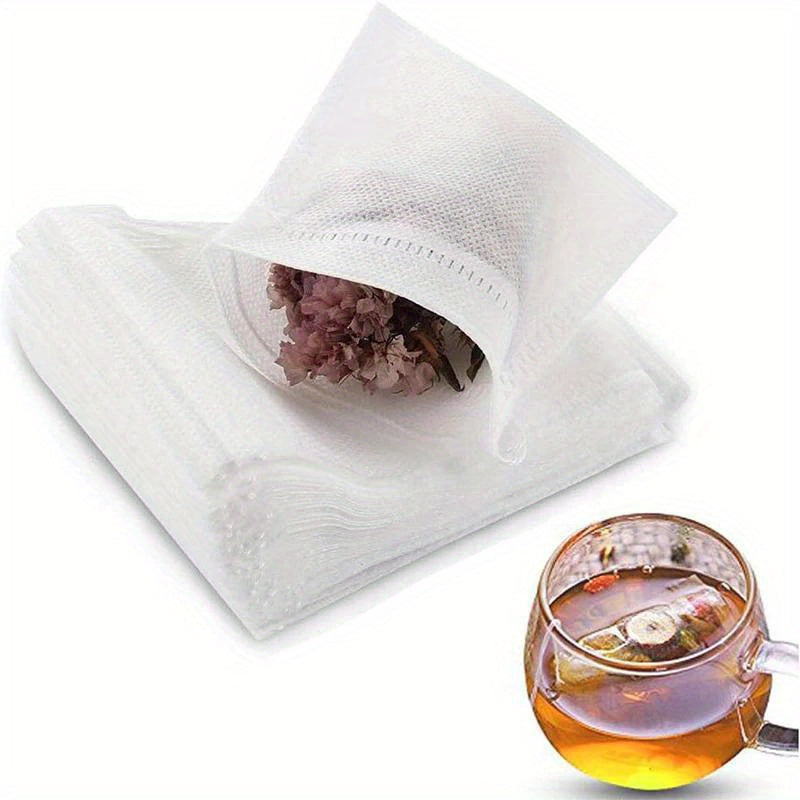 A bundle of 100 tea bags made from nonwoven material, complete with drawstrings, perfect for loose leaf tea, herbs, and spices. Comes in various sizes (6cm x 8cm, 7cm x 9cm, 8cm x 10cm).