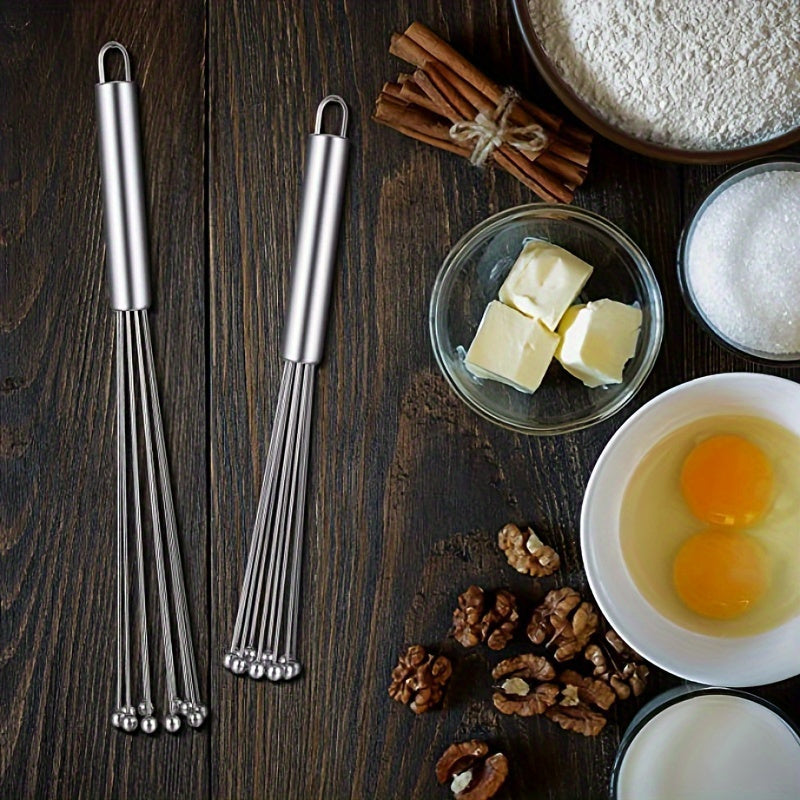 The Stainless Steel Egg Beater Whisk is a manual kitchen whisk set perfect for cooking, mixing, and stirring. This durable whisk requires no electricity to use.