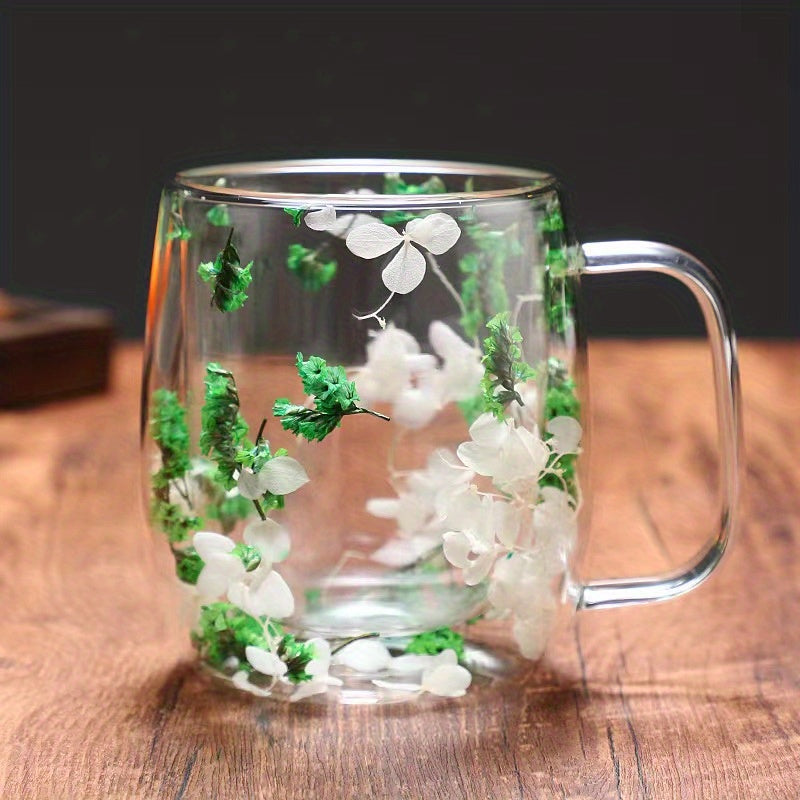 Enjoy your favorite hot or cold beverages in this stylish and durable double-walled glass coffee mug featuring a real flower design. Perfect for use at home or in the office.